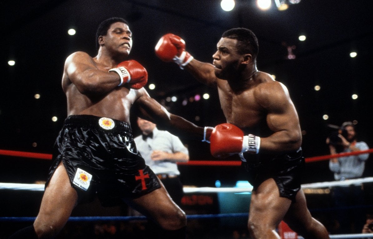 Mike Tyson (right) attacks Berbick. Photo by THE RING