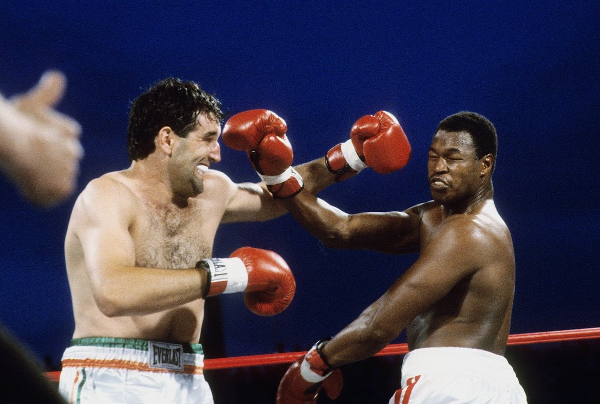 Larry Holmes (right) avoids Gerry Cooney's lethal left hook. Photo by The Ring Magazine