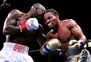 Shawn Porter (right) boxed from a distance for much of his fight against Yordenis Ugas on March 9 in Carson, California, but still utilized his trademark infighting to eke out a split-decision victory. (Photo by German Villasenor)