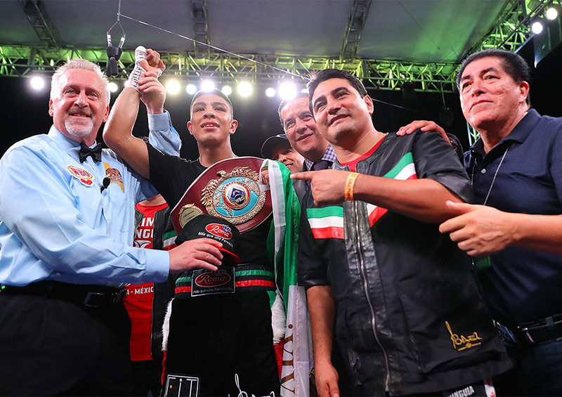 Jaime Munguia (second from left) celebrates his KO of Patrick Allotey with new trainer Erik Morales. Photo by Tom Hogan-Hoganphotos / Golden Boy Promotions