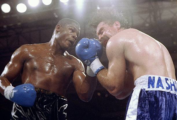 Riddick Bowe (left) trades blows with Pierre Coetzer.