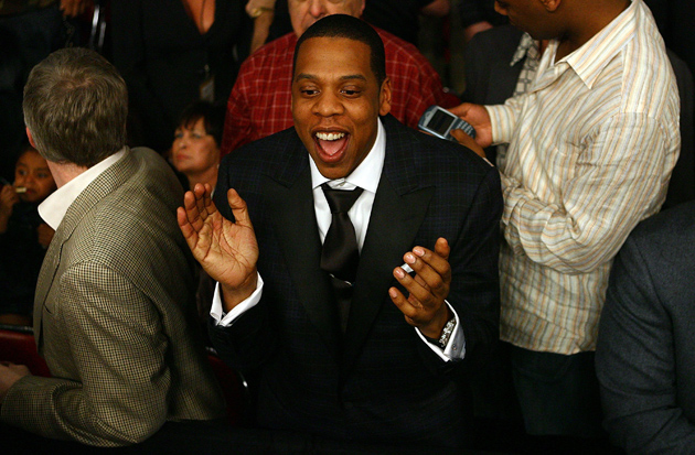 Jay-Z claps during the Floyd Mayweather-Zab Judah fight at Thomas & Mack Arena on April 8, 2006 in Las Vegas, Nev. The rap mogul, who has been a fixture at big prize fights for the past two decades, is now in the business of making them. Photo by Al Bello-Getty Images