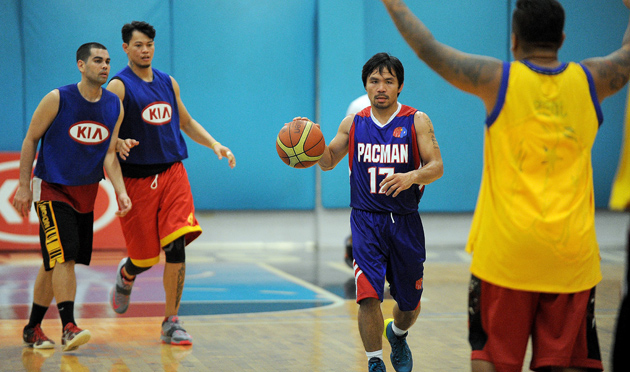 Manny Pacquiao dribbles during practice with the Kia Motors team of the Philippine Basketball Association in Manila on Aug. 15. The 35-year-old boxing Filipino legend joined the draft for new players on Aug. 24 before flying to China to promote his Nov. 22 fight against Chris Algieri. Photo by Jay Directo/AFP/Getty Images