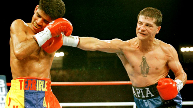 Johnny Tapia (R) defending his WBO junior bantamweight title against Ivan Alvarez on June 7, 1996. Photo by Vince Bucci - AFP/Getty Images.
