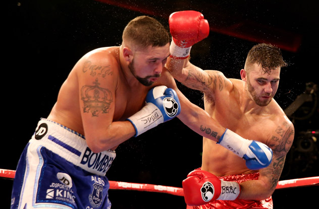 Tony Bellew (L) catches a right hand while taking it to Nathan Cleverly during their heated rematch in Liverpool, England, on Nov. 22, 2104. Bellew won a split decision. Photo by Scott Heavey / Getty Images