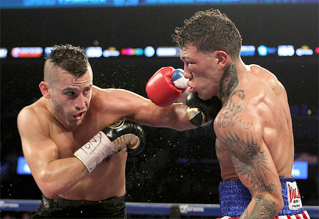 Gabriel Rosado (right) takes a big left from David Lemieux during their entertaining shootout on Dec. 6, 2014, in Brooklyn, New York. Photo by Tom Hogan / Hoganphotos-Golden Boy Promotions