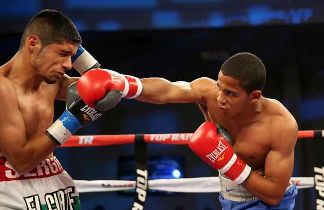 Lightweight prospect Felix Verdejo (R) punches Sergio Villanueva on his way to a third-round knockout victory on Oct. 4, 2014. Photo by Alex Menendez/Getty Images.