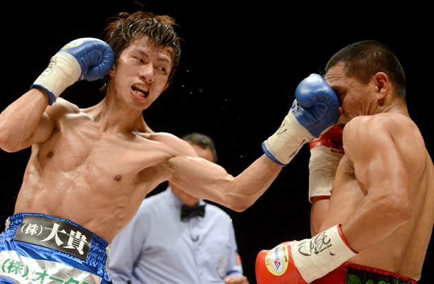 Ryoichi Taguchi (L) scores en route to taking the WBA junior flyweight title from Alberto Rossel on Dec. 31, 2014, in Tokyo. Photo by Naoki Fukuda.