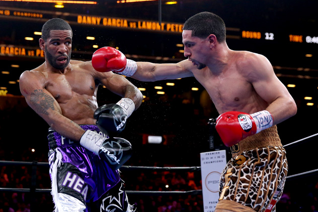 Danny Garcia Pursues  Lamont Peterson during their bout at Brooklyn's Barclays Center on April 11, 2015. Garcia won a disputed decision.  Photo by Elsa/Getty Images