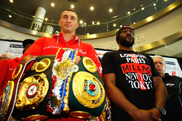 Wladimir Klitschko displays his collection of belts next to April 25 opponents Bryant Jennings. Photo by Al Bello/Bongarts-Getty Images.