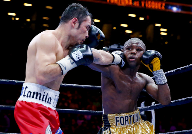 Javier Fortuna (R) and Bryan Vasquez connect simultaneously during their fight on May 29, 2015. Photo by Al Bello/Getty Images.