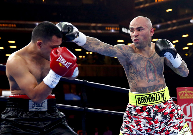 Luis Collazo (R) pops Christopher Degollado en route to a second-round TKO in April 2015. Photo by Elsa/Getty Images.