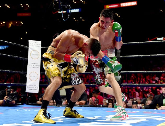 LOS ANGELES, CA - AUGUST 29:  Leo Santa Cruz punches Abner Mares of Mexico during the sixth round of the WBC diamond featherweight and WBA featherweight championship bout at Staples Center on August 29, 2015 in Los Angeles, California.  Santa Cruz would win in a 12 round decision.  (Photo by Harry How/Getty Images)