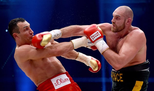 Tyson Fury (R) out-reaching Wladimir Klitschko on his way to become the RING, IBF, WBA and WBO heavyweight champion. Only one more belt remains: the WBC strap held by American Deontay Wilder. (Photo by Lars Baron - Getty Images)
