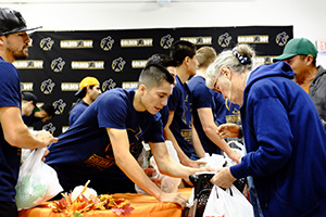Joet Gonzalez helps out with the De La Hoya Foundation's annual turkey giveaway.