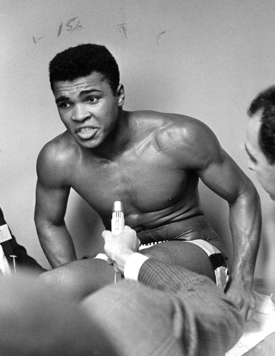 Cassius Clay talks to the press after beating Archie Moore in 1962. 