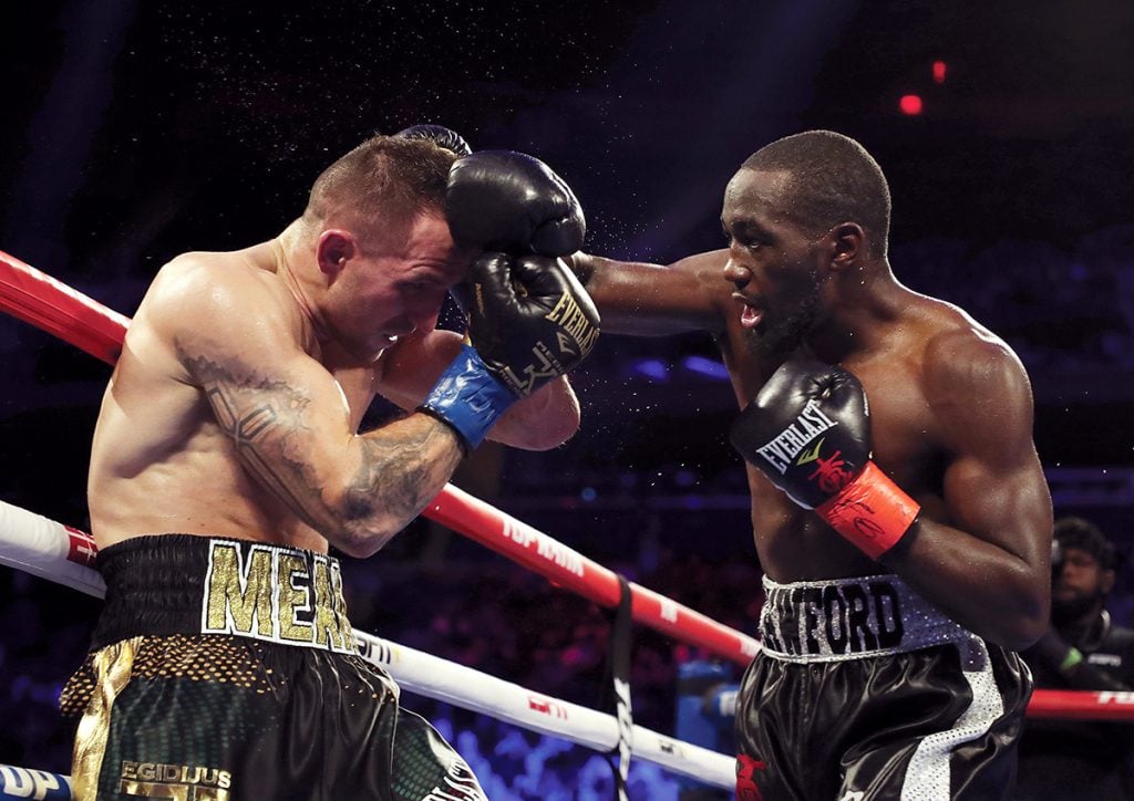 Terence Crawford (right) goes after Egidijus Kavaliauskas. Photo by Al Bello/ Getty Images