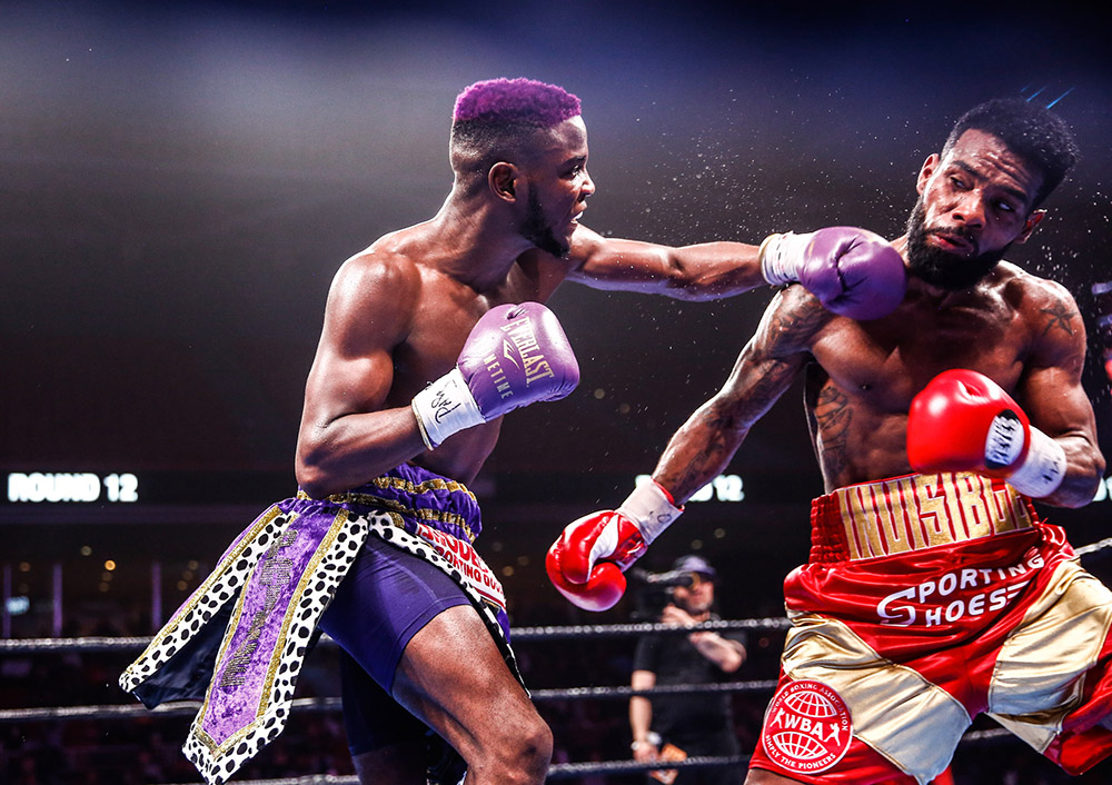 Chris Colbert's (left) combinations weren't as memorable as his color-coordination but the junior lightweight from New York dominated the scorecards in a 10-rounder against former titleholder Jezzrel Corrales. (Photo by Stephanie Trapp)