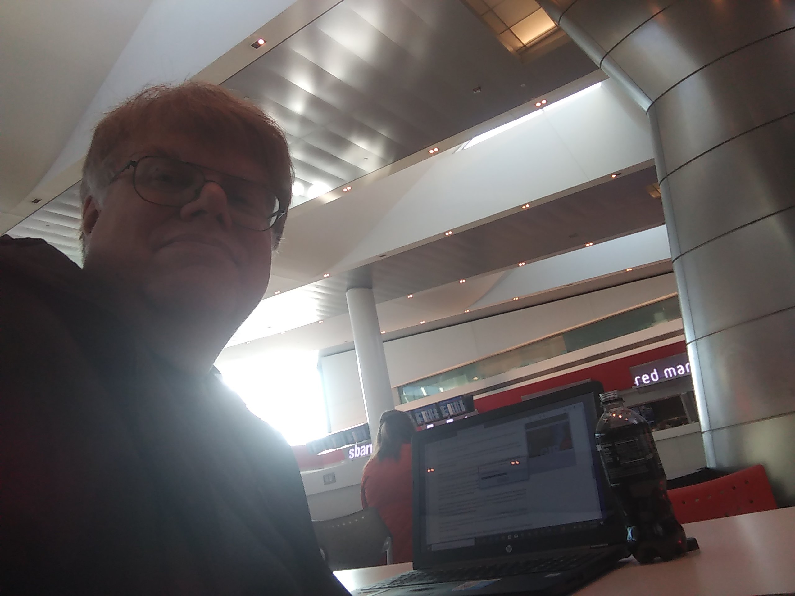 Confronted by a long wait at Philadelphia International Airport, Lee Groves - also known as "The Travelin' Man" - sets up shop following a relaxing meal at the food court.