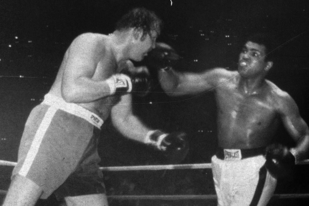 CLEVELAND - MARCH 24,1975: Muhammad Ali (right) connects with a right hand against Chuck Wepner during their fight at Richfield Coliseum on March 24,1975, in Cleveland,Ohio. Ali won the WBA and WBC heavyweight titles by a TKO 15. (Photo by: The Ring Magazine/Getty Images)