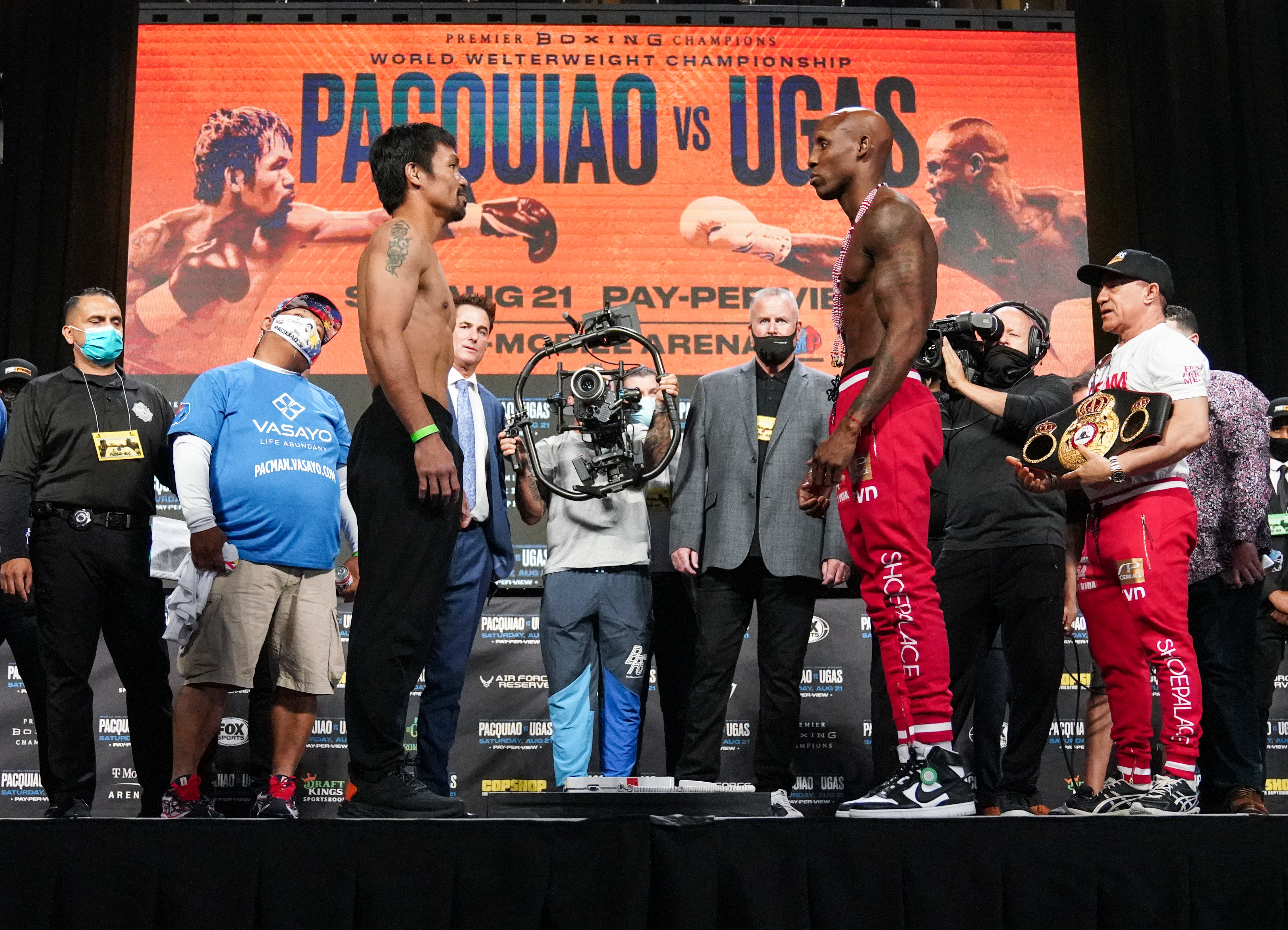 Manny Pacquiao (left) and Yordenis Ugas. Photo by Sean Michael Ham / TGB Promotions