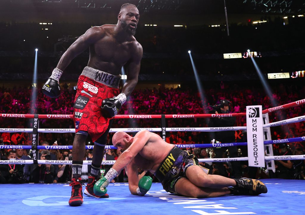 LAS VEGAS, NEVADA - OCTOBER 09: Deontay Wilder (L) knocks down Tyson Fury (R) during their fight for The Ring and WBC heavyweight titles at T-Mobile Arena on October 09, 2021 in Las Vegas, Nevada. (Photo by Mikey Williams/Top Rank Inc via Getty Images)